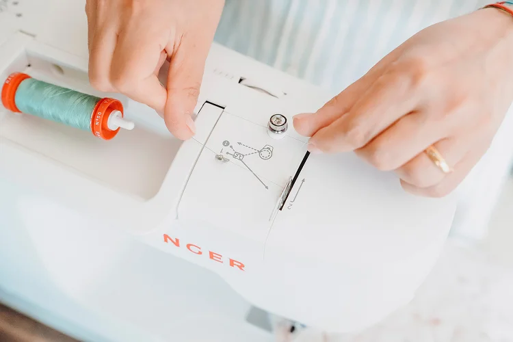 Anna imbastisce a mano un prodotto nel suo atelier.